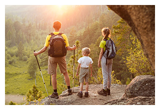 Family stopping their hike to look at the view of the river below